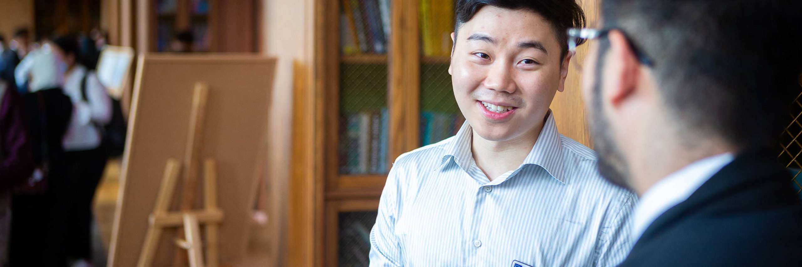 Image of student talking to a member of faculty