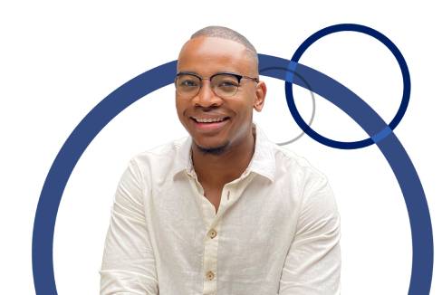 Black student smiling against a circle backdrop
